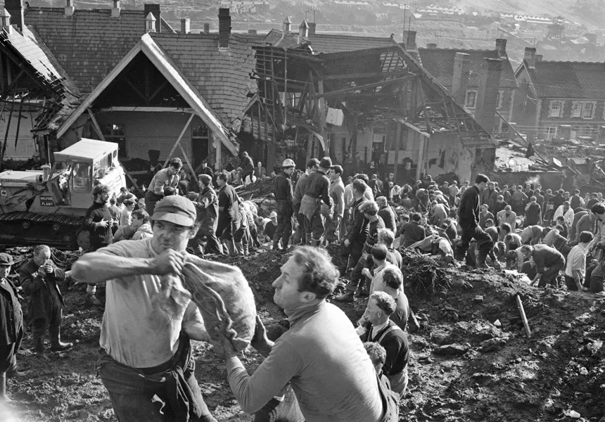 144 people were killed in the small Welsh mining village of Aberfan when tons of slush, from a nearby coal slag tip weakened by rain, slid downhill and engulfed the village school.