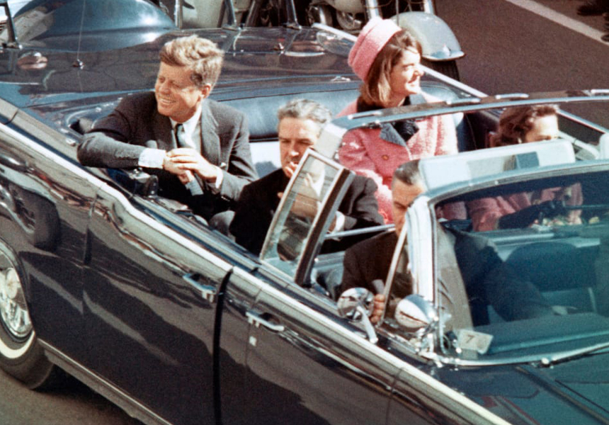 President John F. Kennedy was assassinated as he rode in a motorcade through Dealey Plaza in downtown Dallas, Texas with his wife, Jacqueline Kennedy, Texas Governor John Connally, and his wife, Nelly Connally.